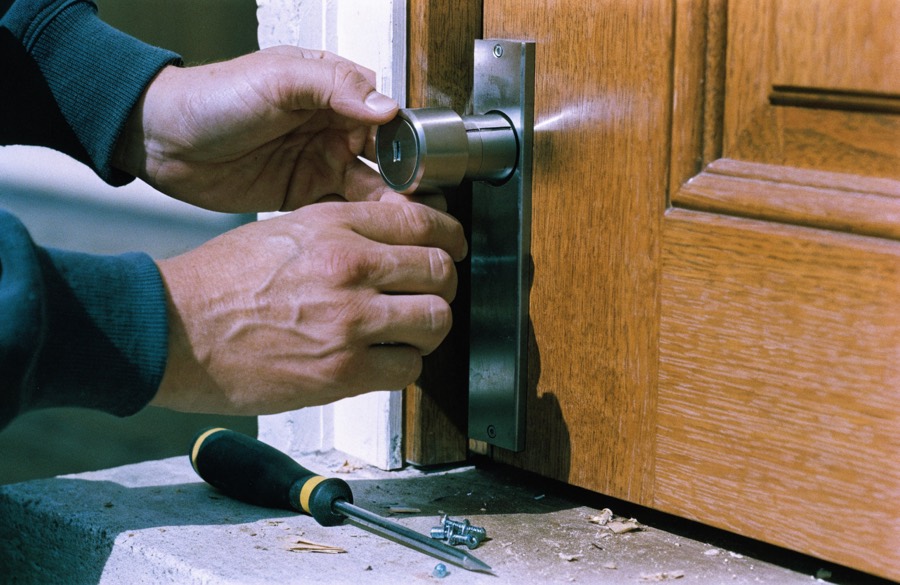 Locksmith installing a deadbolt in a front door